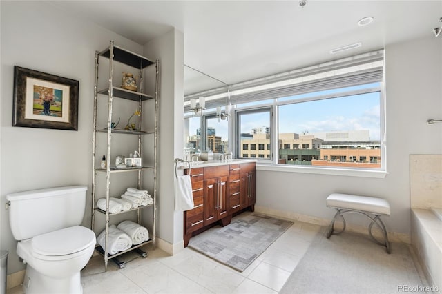 full bath with baseboards, toilet, vanity, and a city view