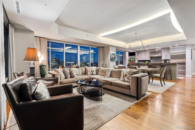 1411 Wynkoop St Unit 806, Denver, CO 80202 - living room with a raised ceiling and light wood-style floors