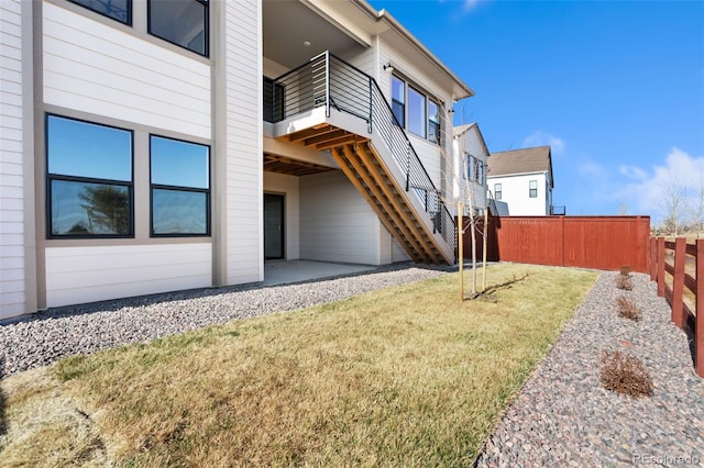 1585 Winter Glow Dr, Windsor, CO 80550 - view of yard featuring stairs, a balcony, a patio area, and fence