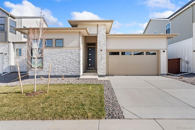 1585 Winter Glow Dr, Windsor, CO 80550 - prairie-style home featuring driveway, stone siding, an attached garage, and a front lawn