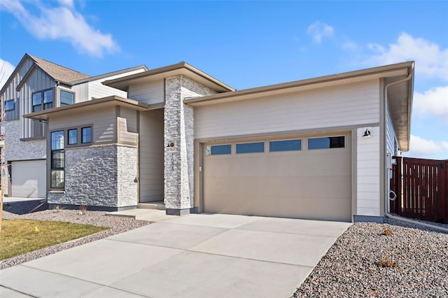 1585 Winter Glow Dr, Windsor, CO 80550 - view of front of home with an attached garage, concrete driveway, and stone siding