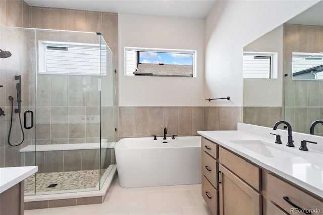 1585 Winter Glow Dr, Windsor, CO 80550 - full bathroom with a stall shower, vanity, and plenty of natural light