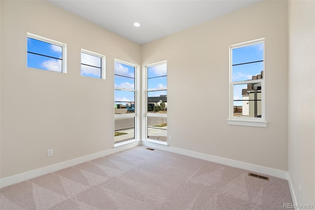 1585 Winter Glow Dr, Windsor, CO 80550 - carpeted spare room featuring visible vents, a wealth of natural light, and baseboards