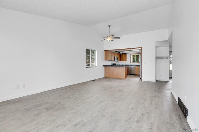 7610 S Garland St, Littleton, CO 80128 - unfurnished living room featuring light wood finished floors, ceiling fan, and high vaulted ceiling