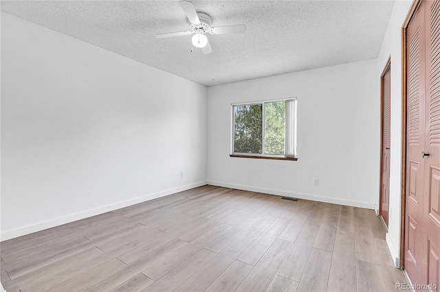 7610 S Garland St, Littleton, CO 80128 - unfurnished bedroom featuring a textured ceiling, light wood finished floors, a closet, and ceiling fan