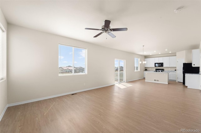 unfurnished living room with ceiling fan, light wood-type flooring, recessed lighting, and baseboards