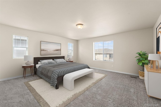 bedroom featuring visible vents, baseboards, and light carpet