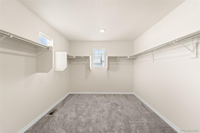 spacious closet with light carpet and visible vents
