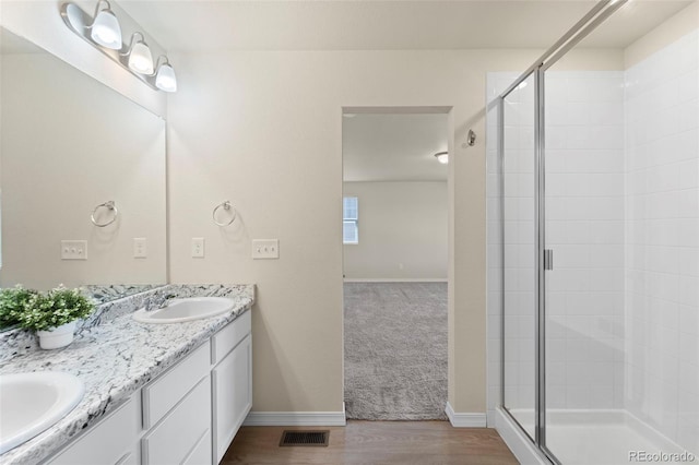 full bathroom with visible vents, a sink, and a stall shower