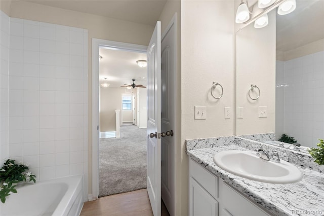 full bath featuring vanity, baseboards, and a ceiling fan