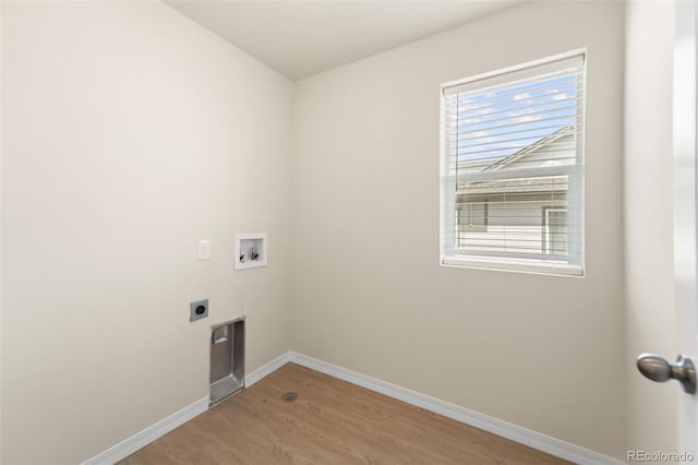 laundry room with laundry area, light wood-style floors, electric dryer hookup, washer hookup, and baseboards
