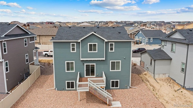back of house with a residential view and fence
