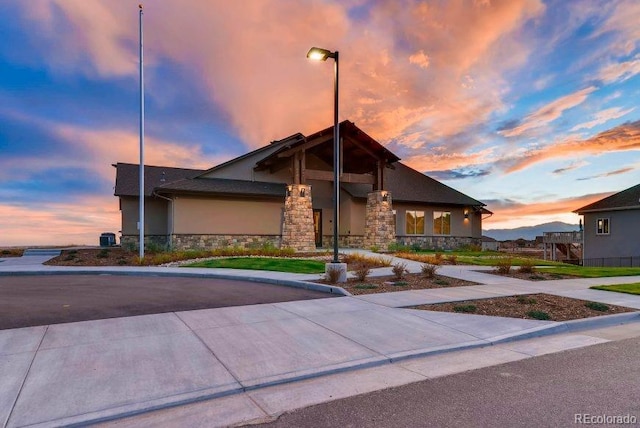 view of front of house with stucco siding and stone siding