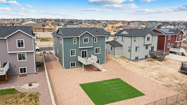 rear view of house with a residential view, stairway, and a fenced backyard
