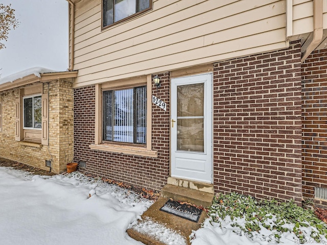 view of snow covered property entrance