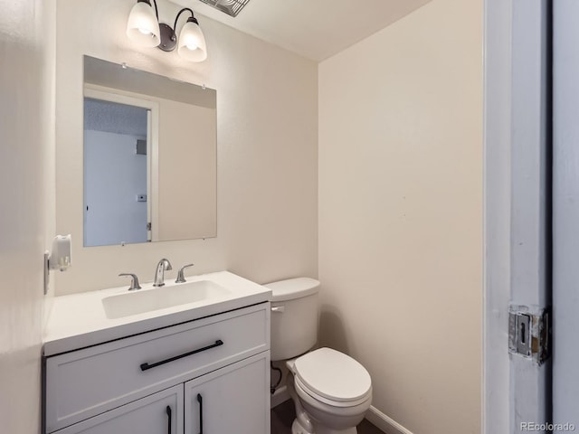 bathroom with toilet and vanity