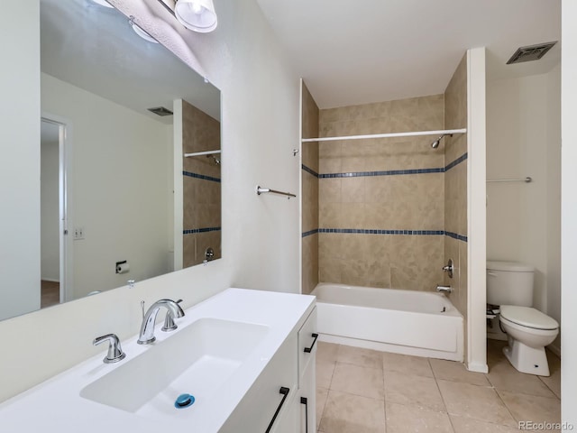 full bathroom featuring vanity, tile patterned floors, toilet, and tiled shower / bath