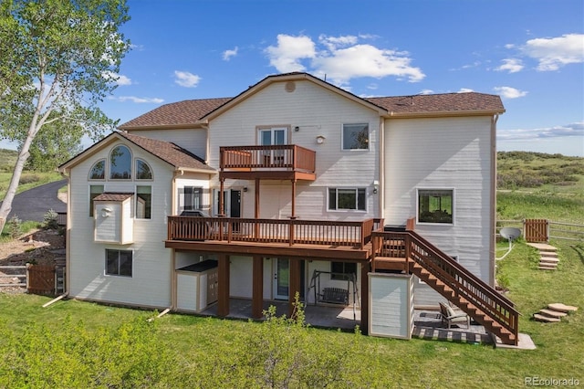 7289 Stroh Rd, Parker, CO 80134 - back of property featuring a balcony, stairway, a yard, and a deck