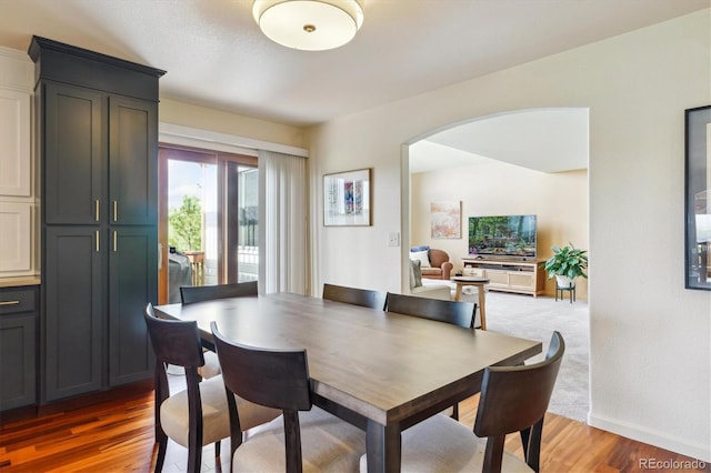 7289 Stroh Rd, Parker, CO 80134 - dining room with light wood finished floors, arched walkways, and baseboards