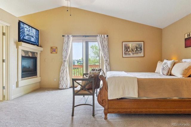 7289 Stroh Rd, Parker, CO 80134 - carpeted bedroom with vaulted ceiling, access to exterior, and a glass covered fireplace