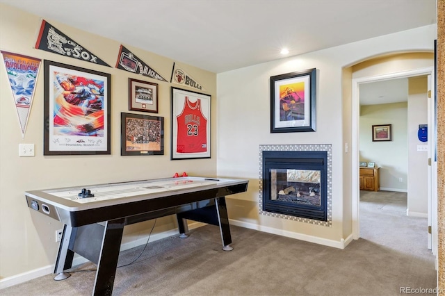 7289 Stroh Rd, Parker, CO 80134 - playroom with carpet floors, a tiled fireplace, baseboards, and recessed lighting