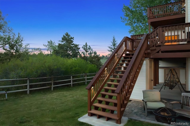 7289 Stroh Rd, Parker, CO 80134 - view of playground with stairway, an outdoor fire pit, a wooden deck, and a patio