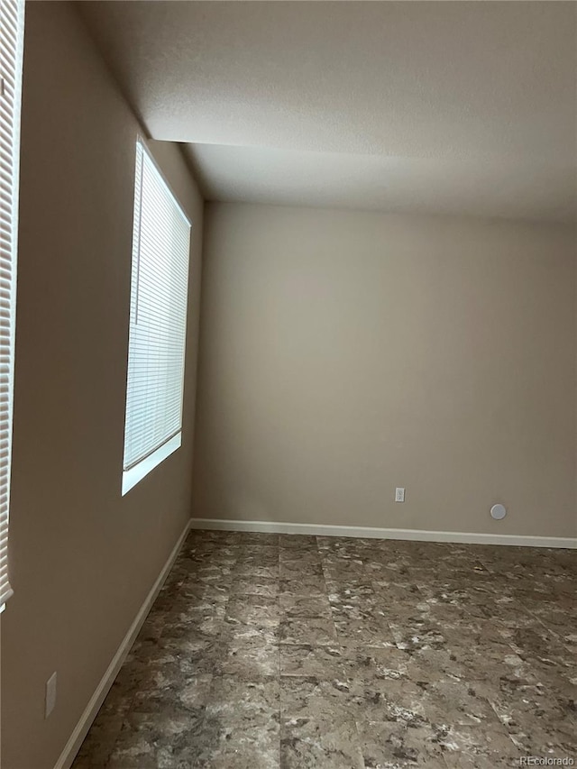 empty room featuring dark tile flooring