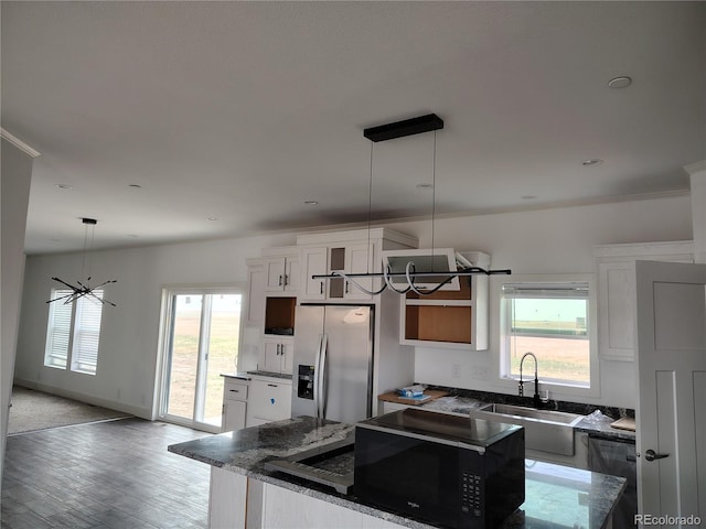 kitchen with white cabinetry, light hardwood / wood-style floors, appliances with stainless steel finishes, and sink