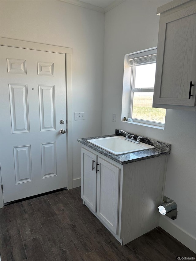 kitchen with white cabinets, sink, and dark hardwood / wood-style floors