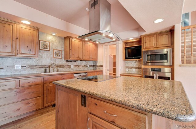 1055 Oak Ridge Rd, Manitou Springs, CO 80829 - kitchen with appliances with stainless steel finishes, a sink, island range hood, a center island, and light stone counters