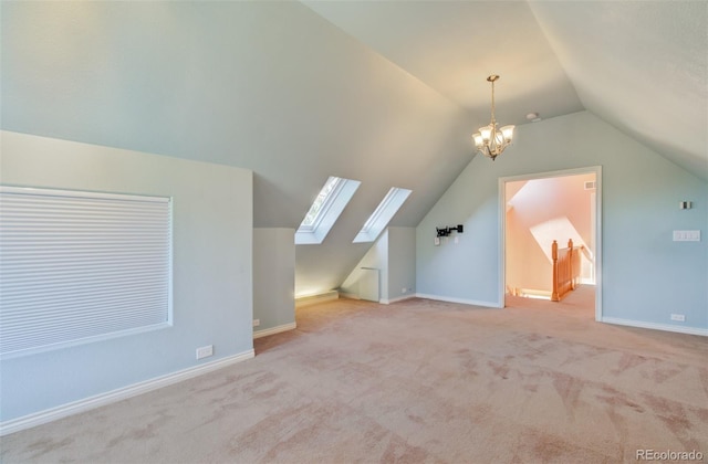 1055 Oak Ridge Rd, Manitou Springs, CO 80829 - additional living space with vaulted ceiling, carpet floors, a chandelier, a skylight, and baseboards