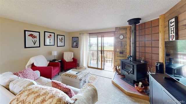 carpeted living room with a textured ceiling and a wood stove