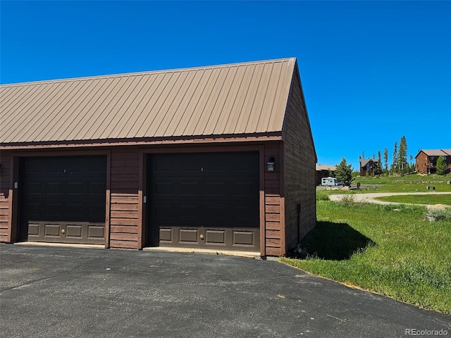 garage featuring a lawn