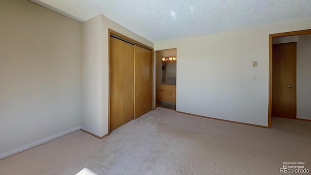 spare room with light carpet and a textured ceiling