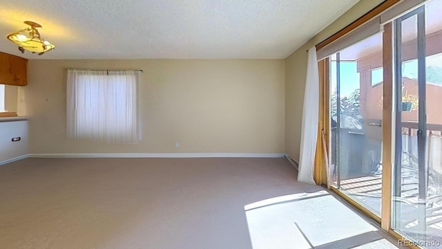 unfurnished room featuring a textured ceiling