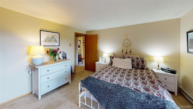 bedroom featuring a baseboard radiator, light colored carpet, and a textured ceiling