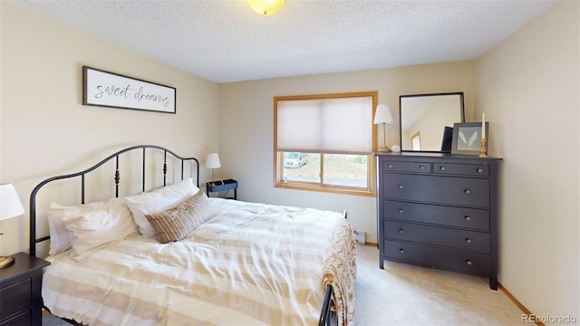 carpeted bedroom featuring a textured ceiling