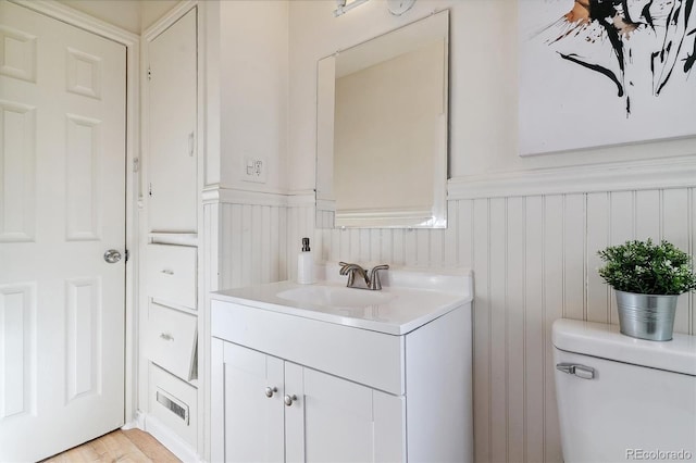 bathroom featuring hardwood / wood-style flooring, vanity, and toilet