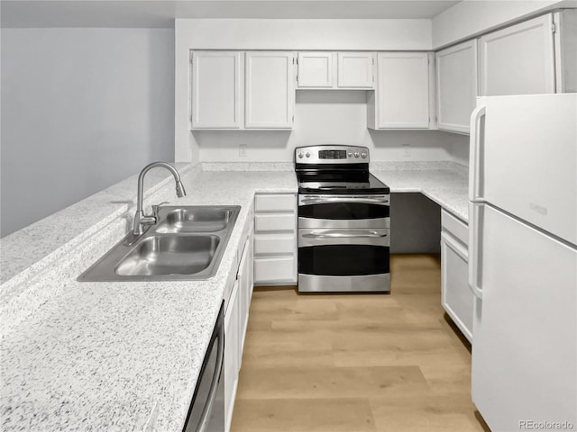 kitchen with white cabinetry, sink, stainless steel appliances, and light hardwood / wood-style floors