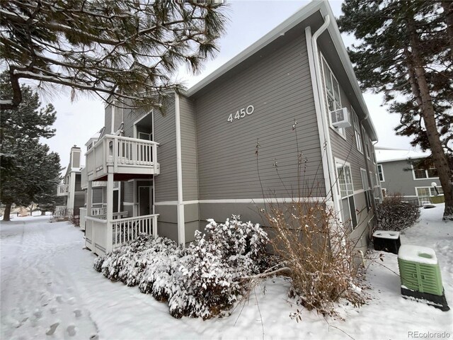 snow covered property with cooling unit