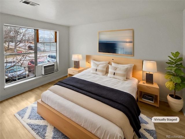 bedroom with hardwood / wood-style floors and cooling unit