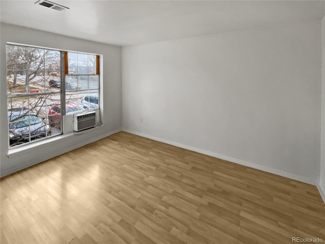 unfurnished room featuring hardwood / wood-style flooring and cooling unit