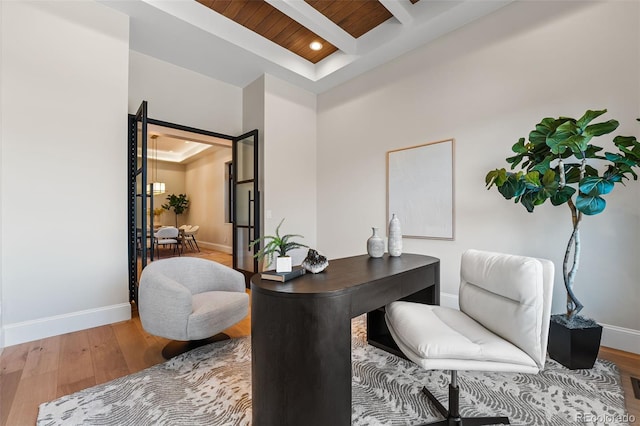 office featuring beamed ceiling, hardwood / wood-style flooring, and wooden ceiling