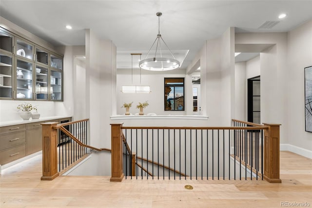 hallway with light hardwood / wood-style floors