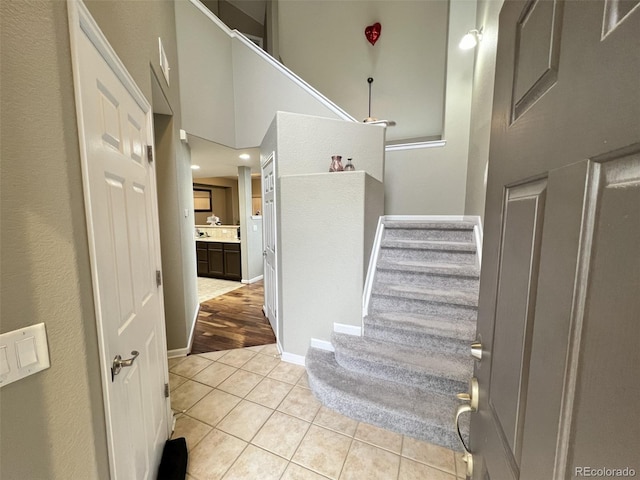 stairs with tile patterned floors