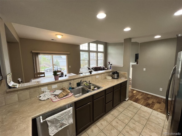 kitchen featuring light tile patterned flooring, appliances with stainless steel finishes, and sink