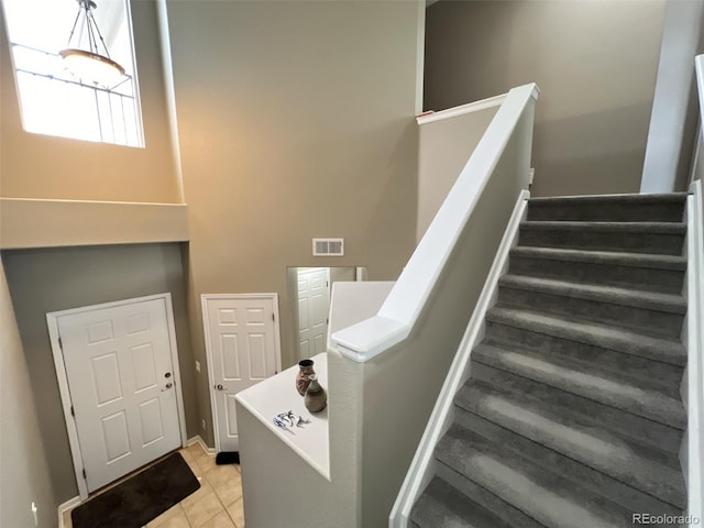 stairway with tile patterned flooring