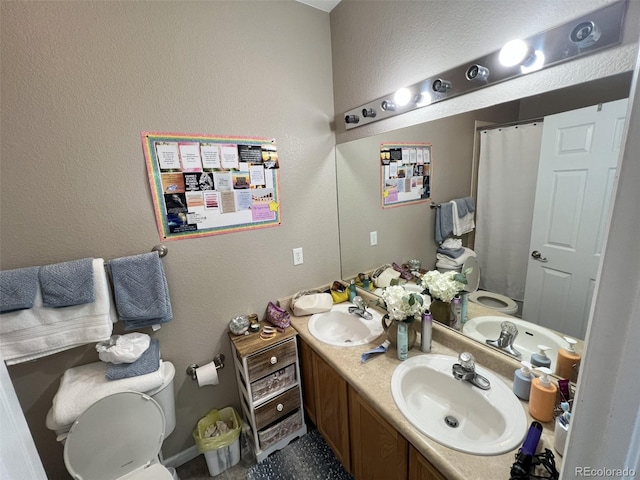 bathroom featuring vanity and toilet