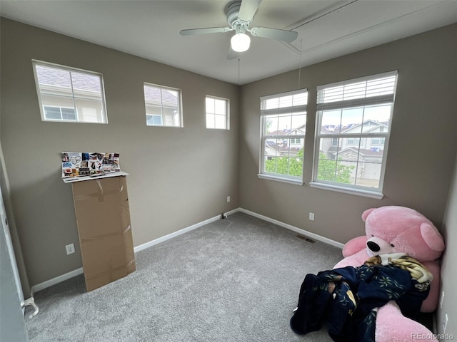 interior space featuring carpet floors and ceiling fan