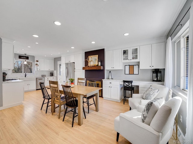 dining room featuring sink and light hardwood / wood-style floors